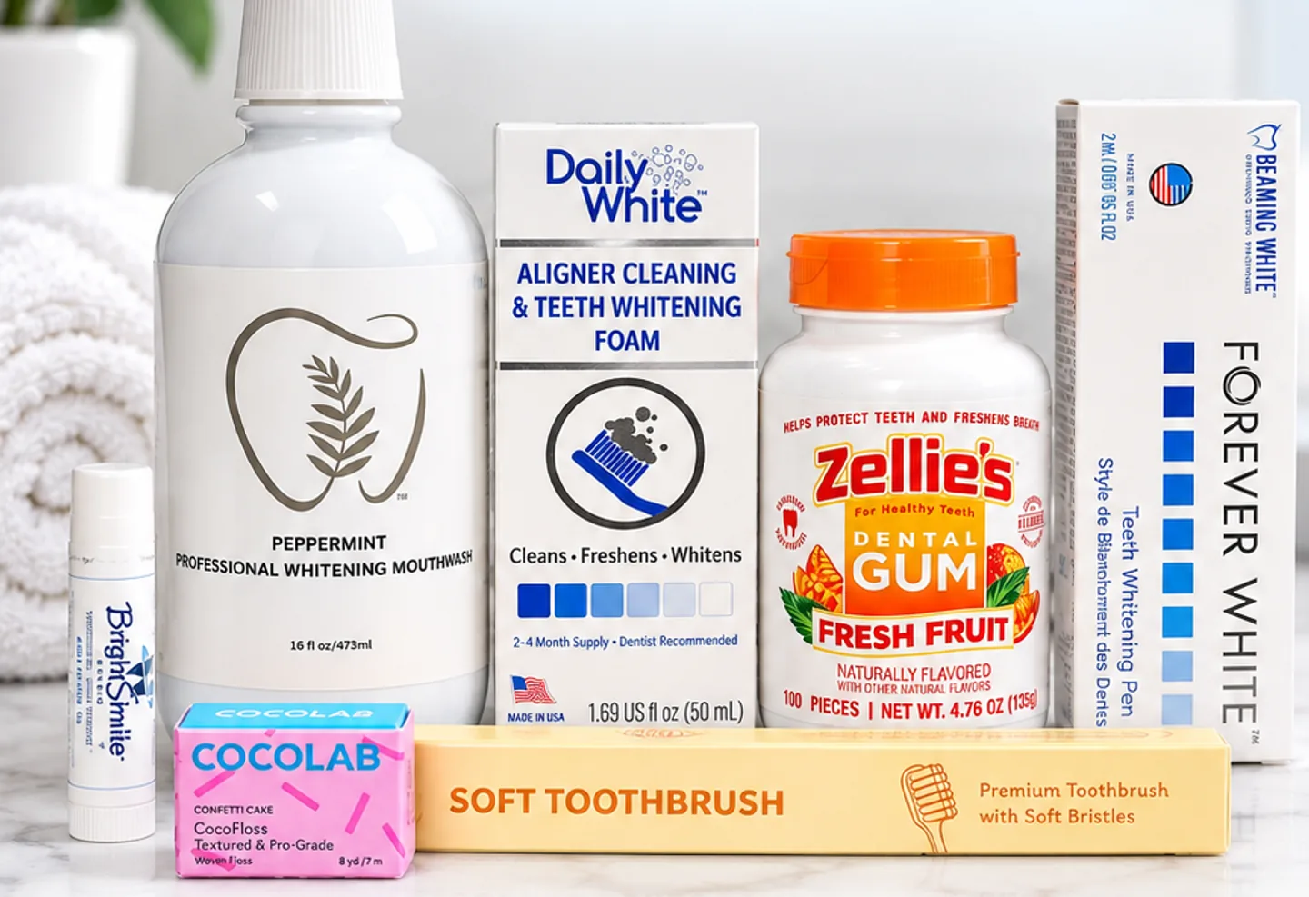 The BrightSmile Professional Teeth Whitening Care Kit: whitening mouthwash, Daily White foam, a Forever White whitening pen, Zellie’s dental gum, a soft toothbrush, Cocofloss and a BrightSmile lip balm